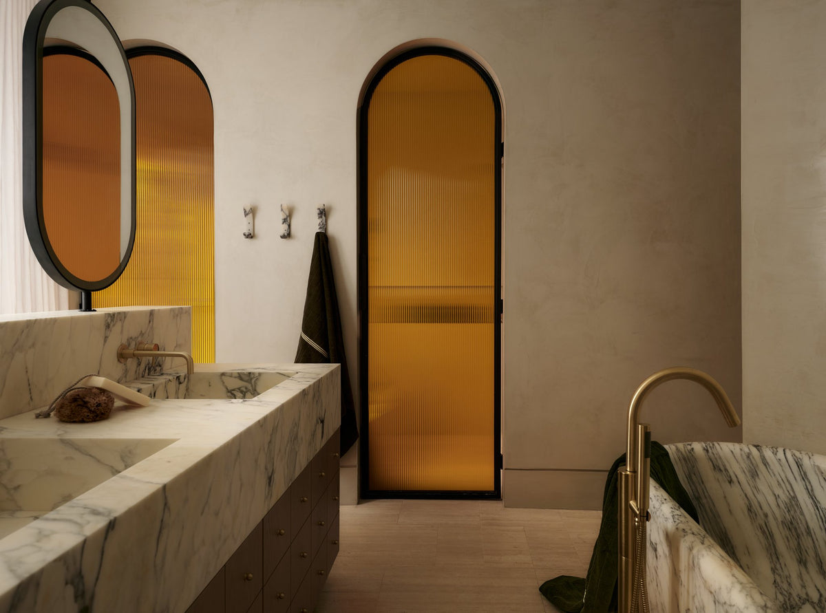 Bathroom with marble vanity, amber arched doors and Longbeach marble hooks