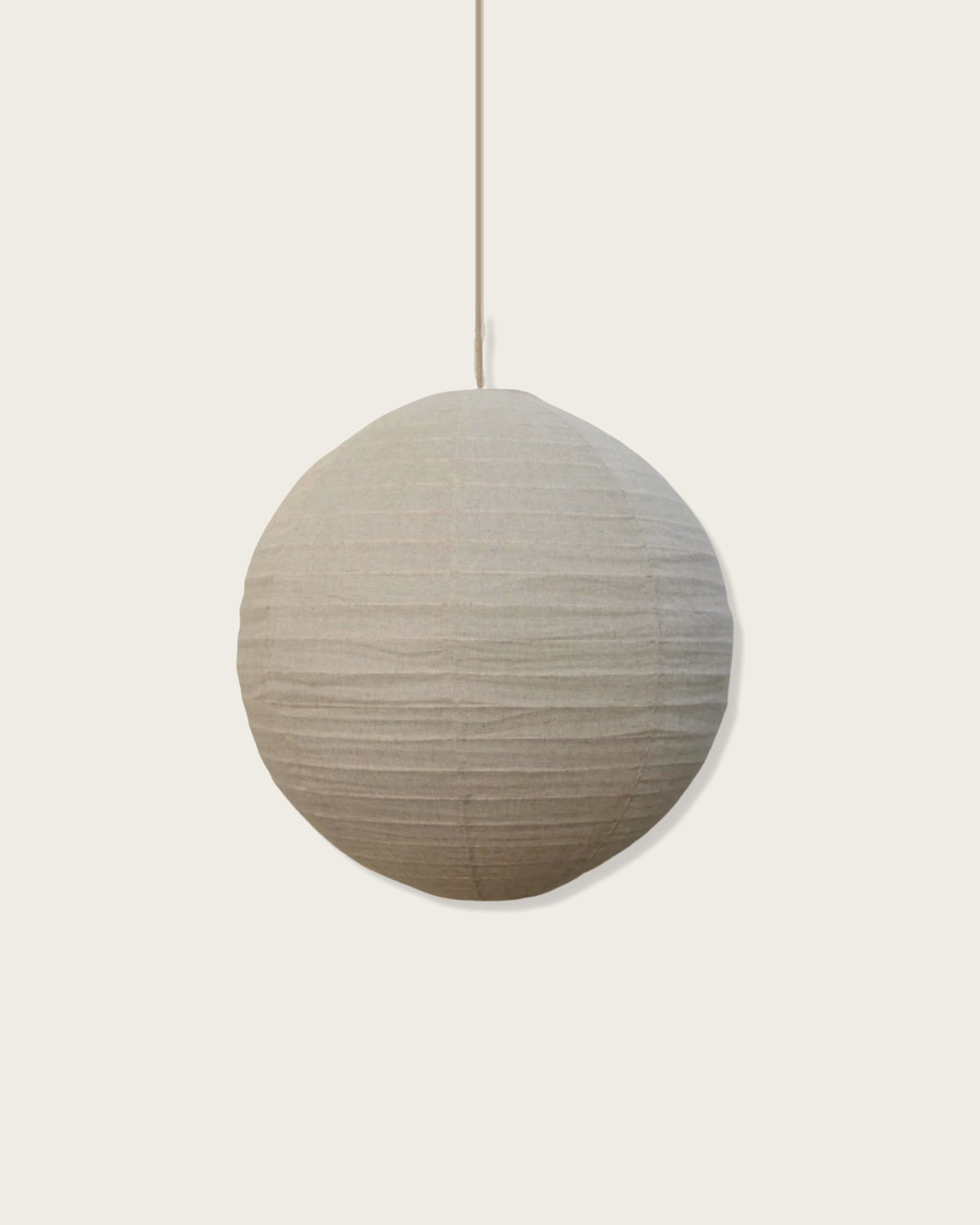 A round pendant light with a soft shade